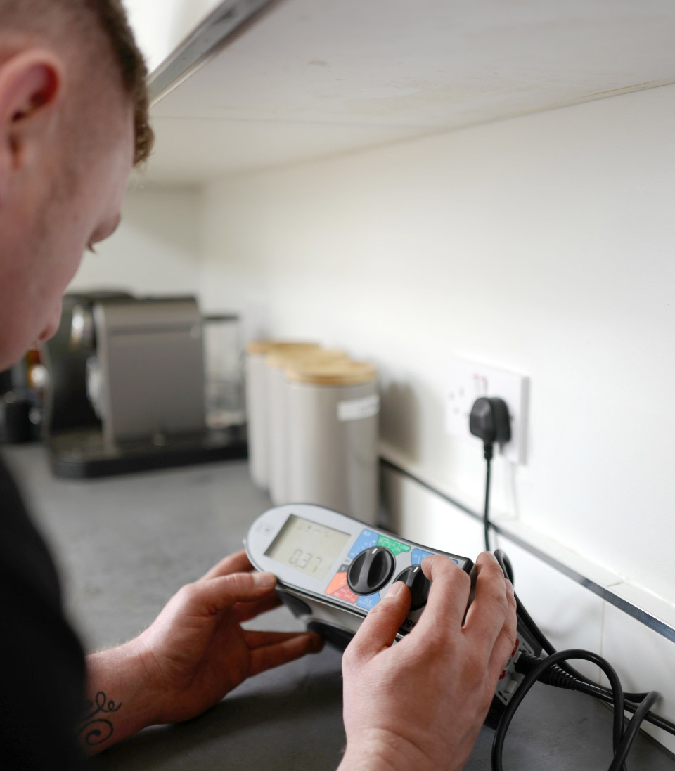 Man looking at an electronic testing meter